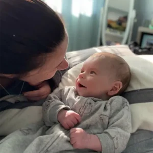 Intimate view of a new mom looking looking lovingly at her newborn.